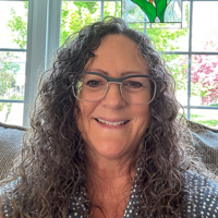 Diana-Aguglia_200x200 photo of woman with long dark and curly hair, wearing glasses